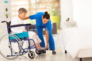 woman in wheelchair in hospital with nurse